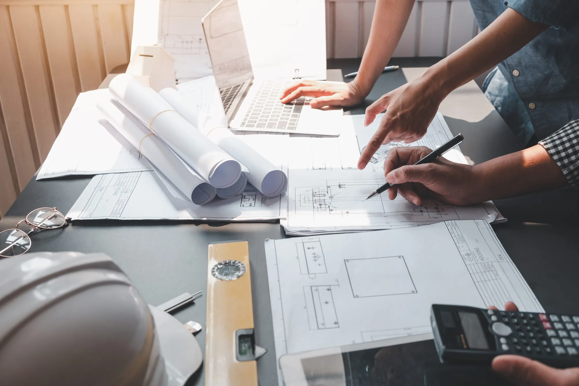 Architect man engineer construction concept using blueprints at the office.